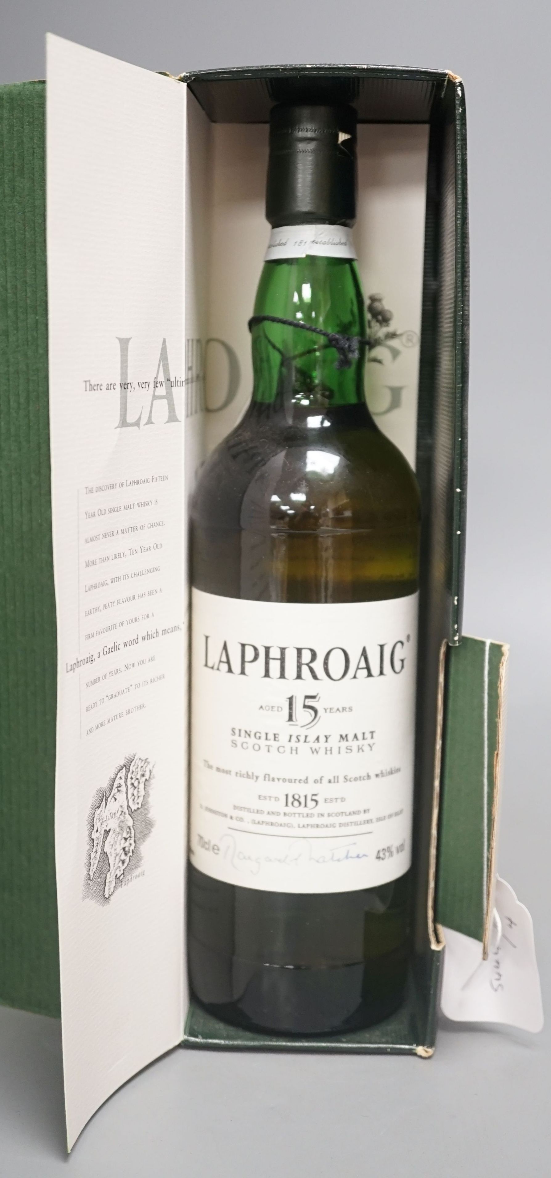 A cased bottle of Laphroaig single Islay malt whisky signed by Margaret Thatcher.